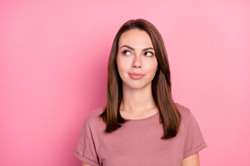 Fototapeta premium Photo of dreamy charming young lady wear casual outfit smiling looking empty space isolated pink color background