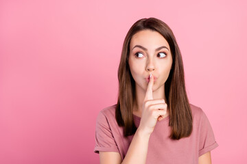 Photo of young girl cover lips finger shh keep secret confidential no talking isolated over pink color background