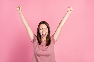 Photo of hooray brunette millennial lady hands up yell wear t-shirt isolated on pink color background