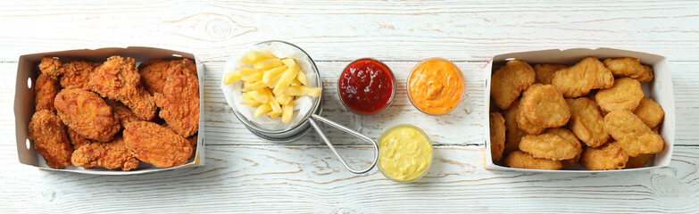 Concept of fast food on white wooden table