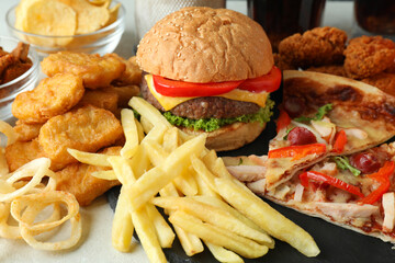 Concept of fast food on white textured table