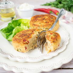 Fish cutlets prepared from tuna and potatoes, with the addition of chili pepper, green parsley and chives.