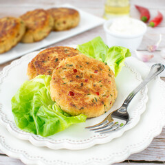 Fish cutlets prepared from tuna and potatoes, with the addition of chili pepper, green parsley and chives.