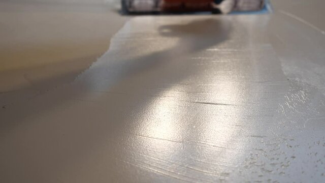 builder applies the plaster with a trowel and smoothes the surface. fresh coating shines