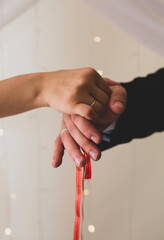 Picture of man and woman with wedding ring.Young married couple holding hands, ceremony wedding day. Newly wed couple's hands with wedding rings.