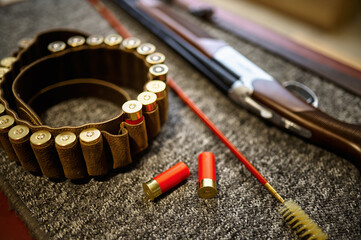 Hunting rifle, bandolier and ramrod in gun store
