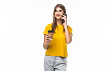 Photo of woman standing with smartphone and takeaway coffee in hands isolated over gray background