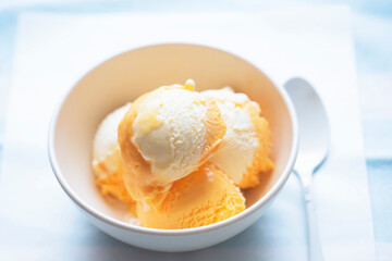Orange and cheese ice creams in bowl 