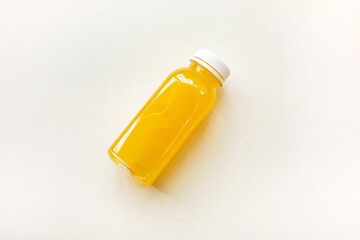 Bottles of freshly squeezed orange juice on a white background. The concept of a healthy diet, detox or diet
