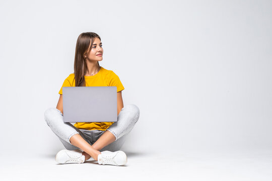 Woman Working On A Laptop Over A White Backgorund