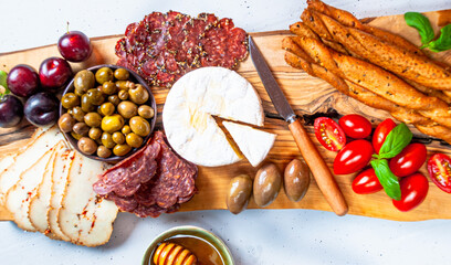 Charcuterie board with camembert cheese