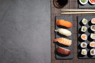Variety of sushi on dark background. Sushi set with copyspace.