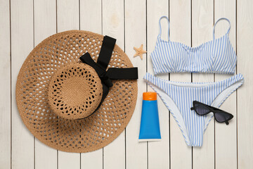 Different beach objects on white wooden background, flat lay