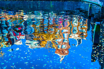 Colorful illustration of the buildings reflection along the canal in Amsterdam in the autumn