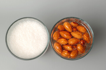 Top view of glasses with soaked almonds and with almonds milk. Showing ingredients needed to...