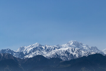 Fototapeta na wymiar View of the picturesque mountain peaks in the haze