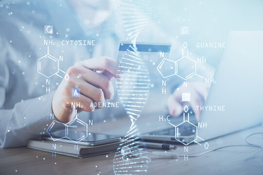 Double exposure of man hands holding a credit card and DNA drawing. On-line Education and E-commerce concept.