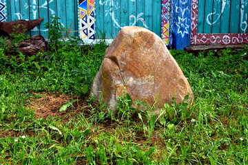 big stone in the grass