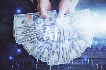 Multi exposure of technology drawing hologram and us dollars bills and man hands. Data concept
