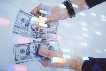 Multi exposure of technology drawing hologram and us dollars bills and man hands. Data concept