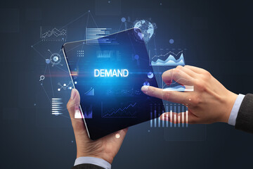 Businessman holding a foldable smartphone, business concept