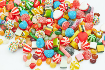 Fototapeta na wymiar Multi-colored gummy candies on a white background. Festive backdrop.