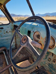 Old broken vintage car dumped in a desert
