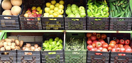 Vegetables and fruits at market. Fresh vegetables and fruits laid out in boxes for sale