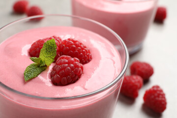 Delicious raspberry mousse with mint in glass bowl, closeup