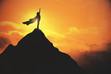 Woman in cape celebrating success on creative backlit mountain and sunset background with mock up...