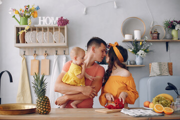 Beautiful family prepare food in a kitchen