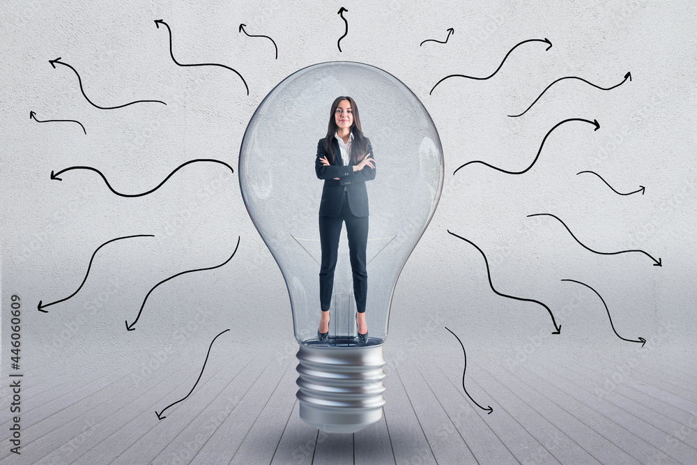 Poster Lightbulb with businesswoman inside and arrows on concrete wall background. Brainstoring and idea concept.