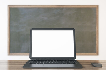 Fototapeta premium Close up of empty white laptop and mouse on chalkboard background, Education, seminar, workshop and mockup concept. 3D Rendering.