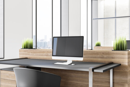 Close up of desk with empty mockup laptop with reflections in modern wooden office interior with window and city view. 3D Rendering.