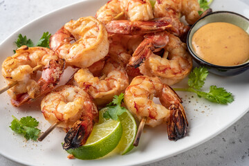 Grilled shrimps. Shrimps skewers, lime and sauce