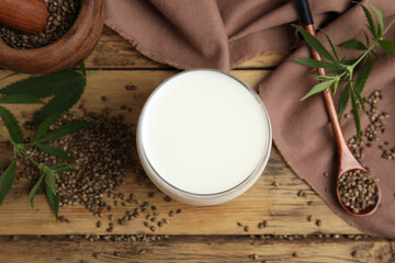 Flat lay composition with fresh hemp milk on wooden table