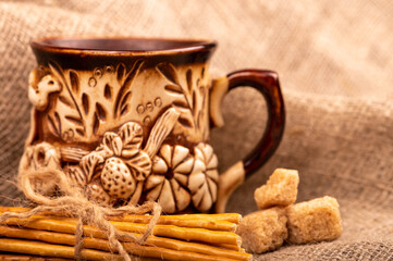 Breadsticks with salt tied with string and an earthenware mug for tea. Close-up Selective focus.