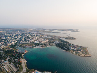 Naklejka premium Panorama of the city at sunset. Bird's-eye view of the evening city beach. Black Sea.