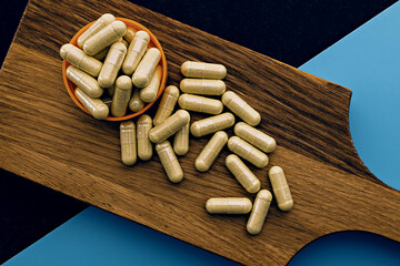 quercetin capsules on wooden board. mental wellbeing and personal health concept