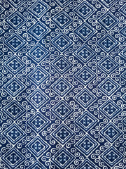 The blue fabric is dyed with a white grid pattern.vertical image