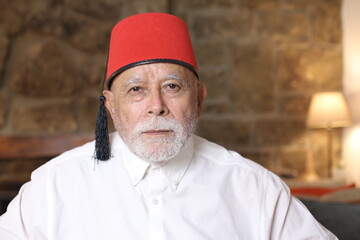 Mature middle Eastern man wearing classic fez hat