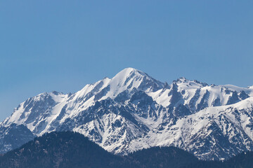 Fototapeta na wymiar Snowy mountain peaks on a clear sunny day