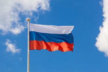 Waving Russian tricolor. The flag of Russia flutters in the wind on a sunny day. Flag of the...