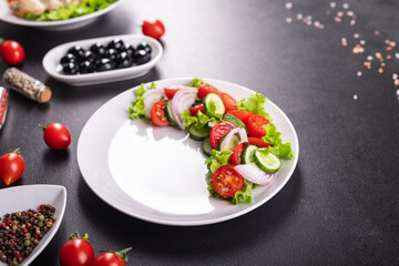 salad vegetables cucumber, tomato, onion, lettuce food organic products meal snack copy space food background rustic. top view keto or paleo diet veggie vegan or vegetarian food