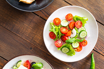 salad vegetables cucumber, tomato, onion, lettuce food organic products meal snack copy space food background rustic. top view keto or paleo diet veggie vegan or vegetarian food