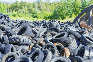 Dump of used automobile tires. Poisonous fumes into atmosphere, environmental pollution and problem of waste recycling concept