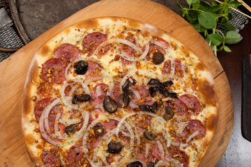 Brazilian pizza with pepperoni, cheese, onion and black olive
