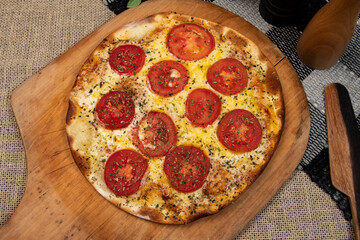 Neapolitan Brazilian pizza with mozzarella cheese and tomato slices with oregano