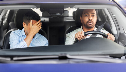 accident, emotion and fear concept - scared car driving school instructor and young male driver