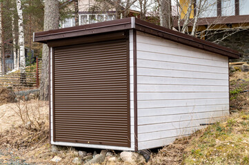 small storage building with shutter instead of door